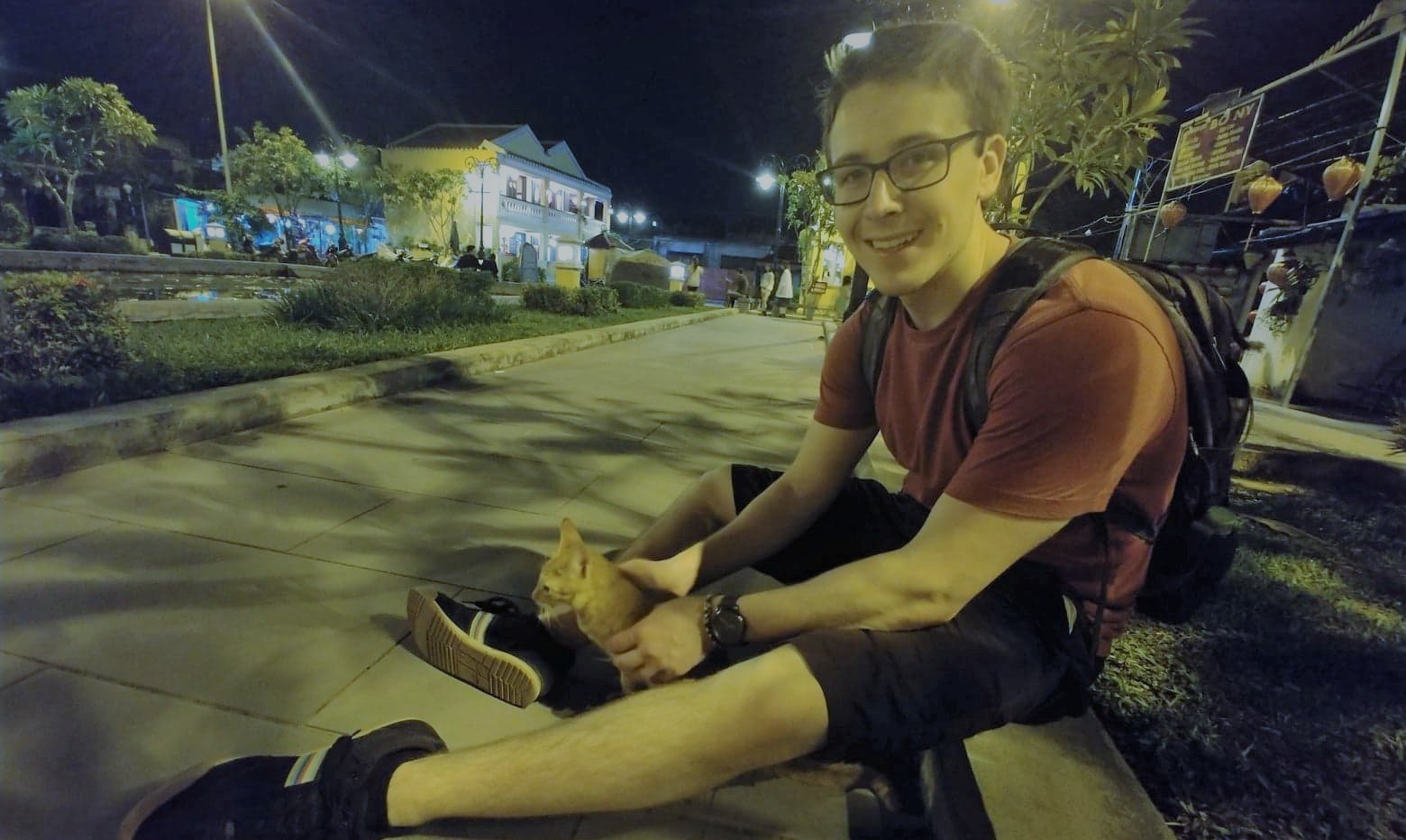 Gaetan with a cat in vietnam